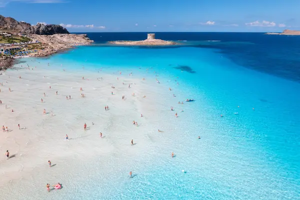 Spiaggia La Pelosa din Stintino cu nisip alb, apă turcoaz și turnul aragonez — sejur charter Sardinia, Italia